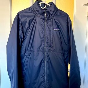 Like new Patagonia light jacket with stowable hood. Beautiful navy blue color.